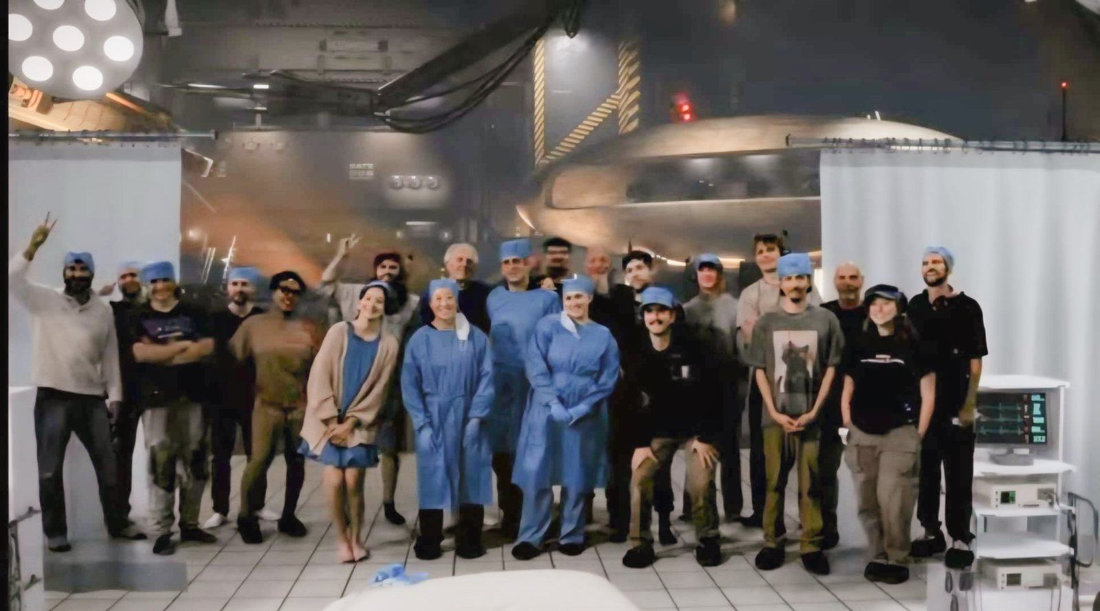 The cast and crew of Mr. Spaceship in a surgical theater set at ABQ Castle Studios, with a spaceship hangar behind them