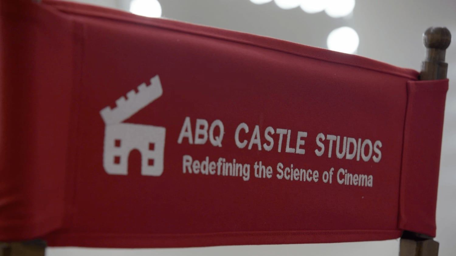 An ABQ Castle Studios director's chair printed with 'Redefining the Science of Cinema'