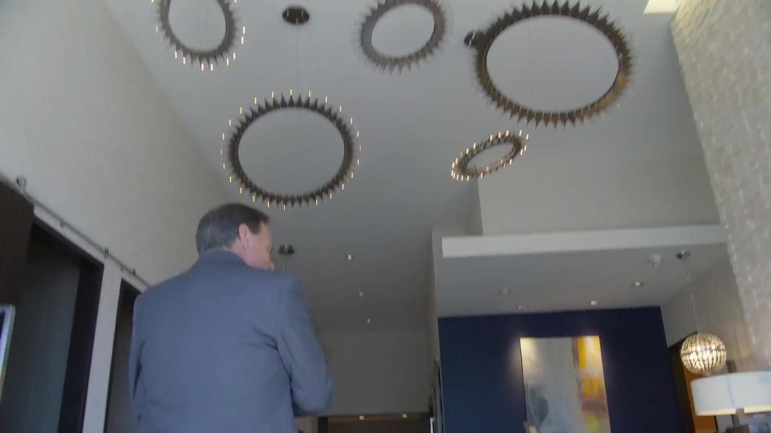 The lobby at ABQ Castle Studios in Albuquerque, with gear-shaped light fixtures on the ceiling, from the studio tour video