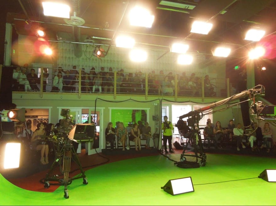 Stadium-style audience seating above the green screen floor during a taping at L.A. Castle Studios Burbank
