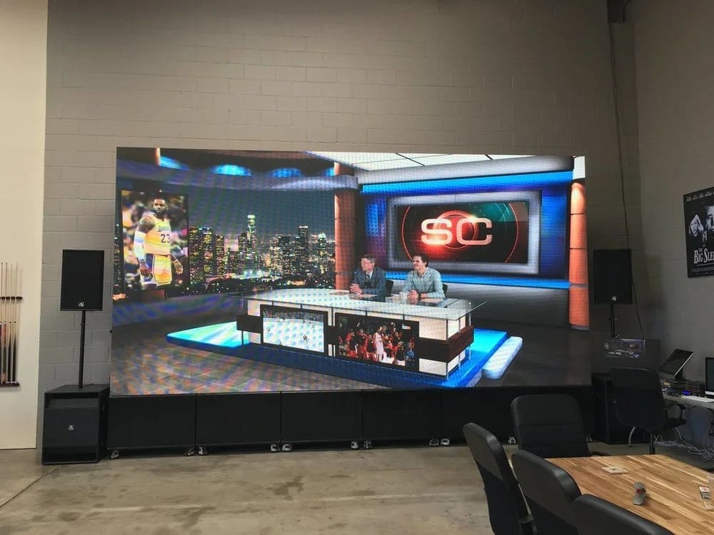 A sports broadcast desk composited live in camera on the Burbank stage