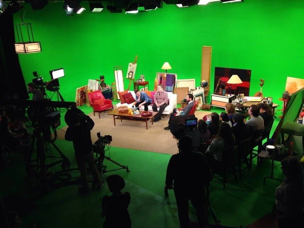 A talk show set built on the green screen floor of the Burbank studio, taped with cameras and a seated studio audience