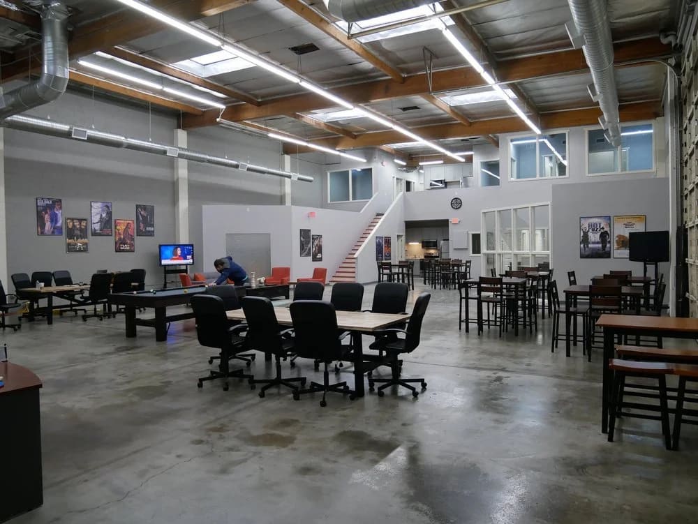 Burbank office space at L.A. Castle Studios: the open production-office common area with conference tables, lounge seating, a pool table, and private offices around the perimeter.
