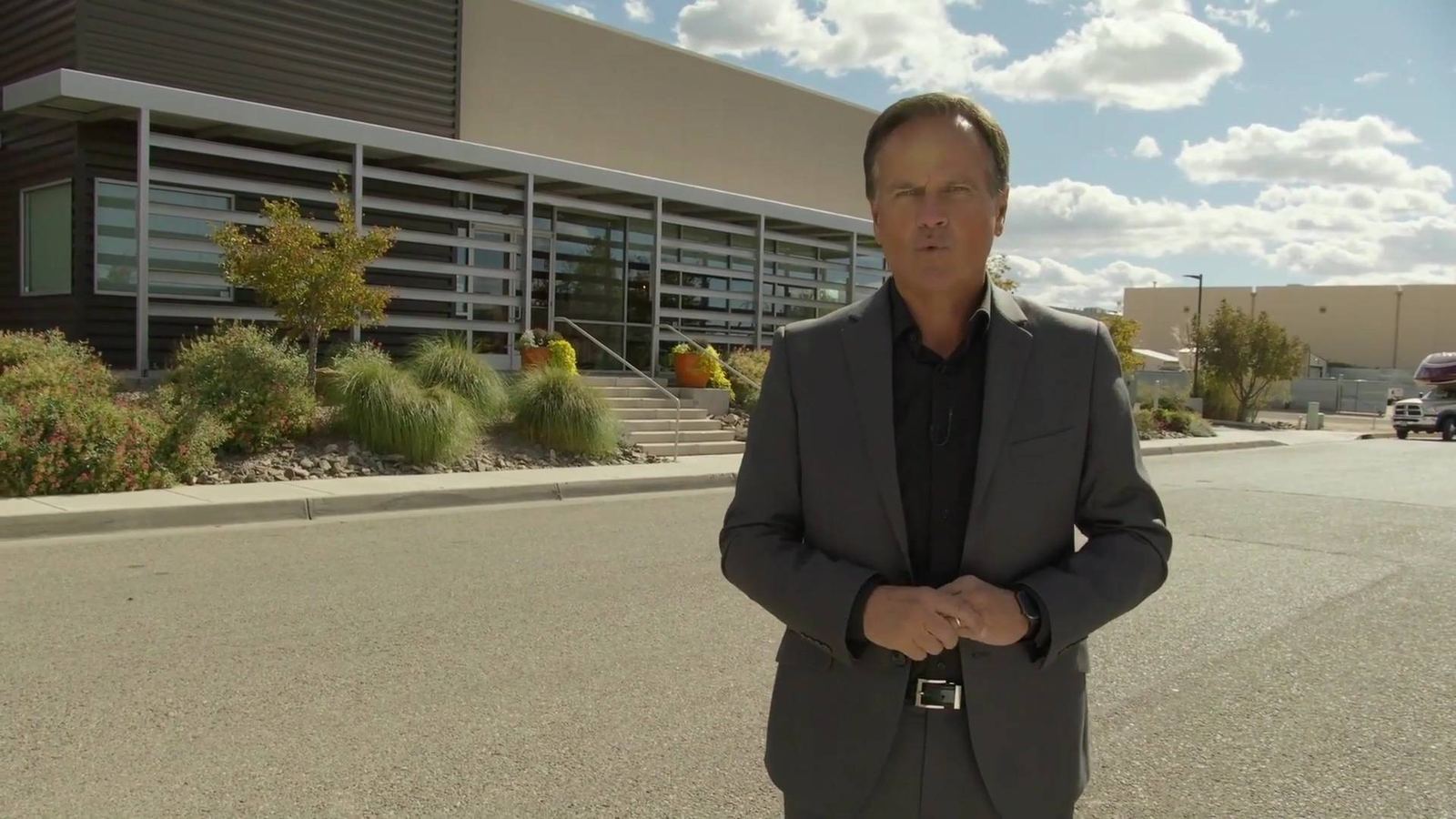 A presenter outside the ABQ Castle Studios building, a film studio in Albuquerque, New Mexico, from the studio tour video