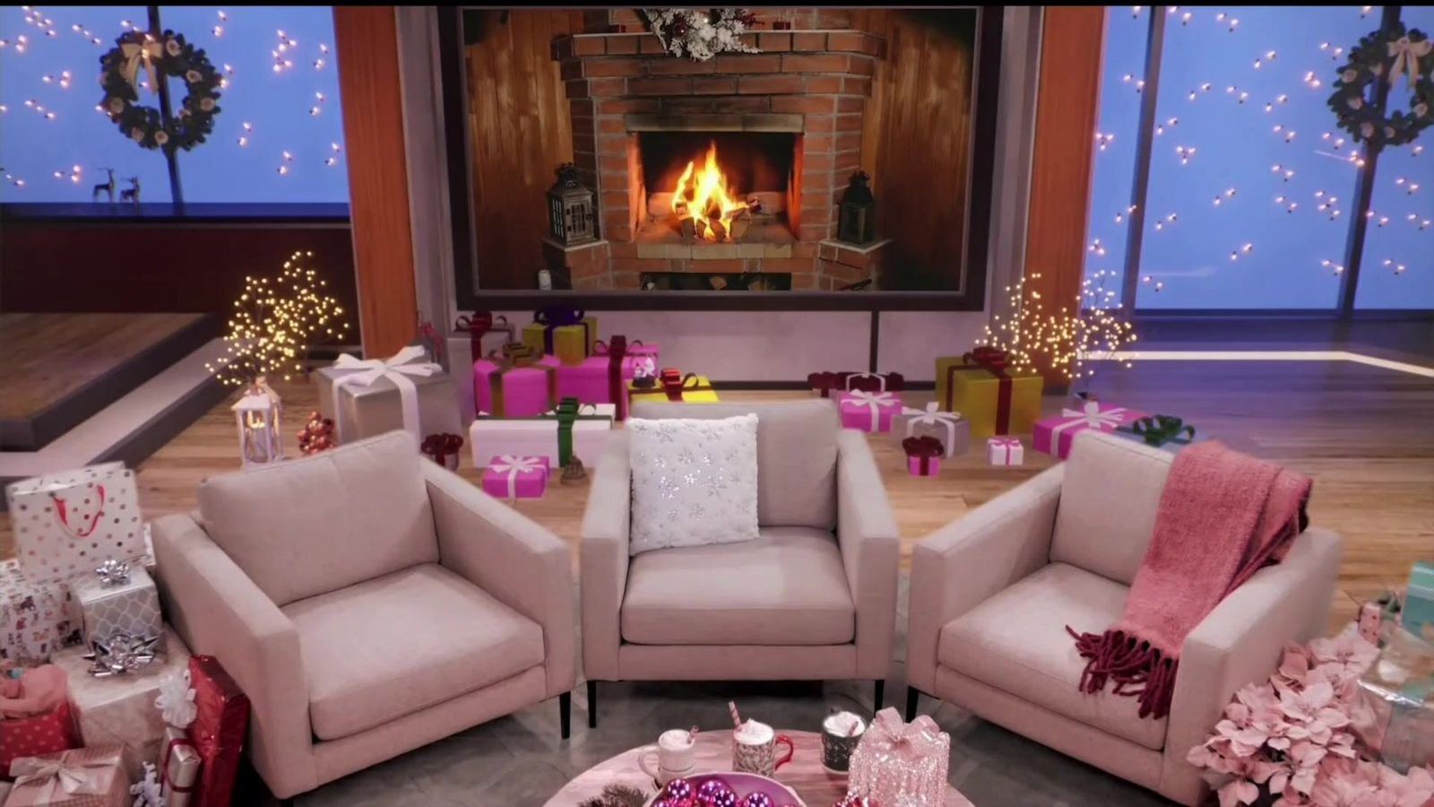 Commercial set: a holiday living room with a crackling fireplace, three armchairs and stacks of wrapped gifts, a virtual set at L.A. & ABQ Castle Studios