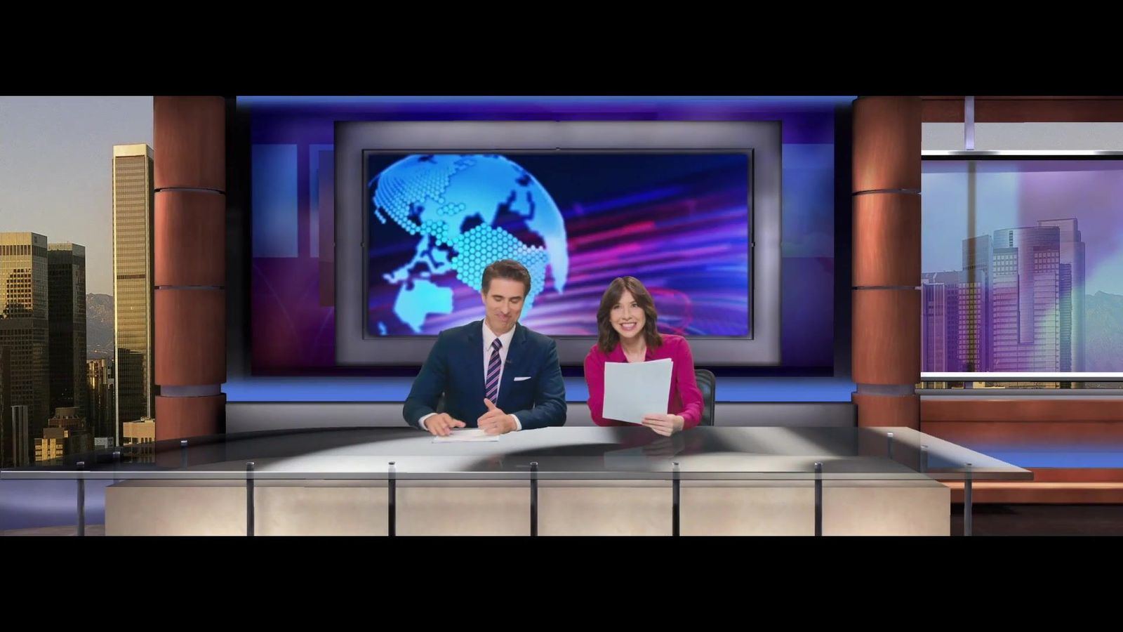 Commercial: two anchors at a news desk before a globe graphic and a city-skyline window, a news-style commercial set at L.A. & ABQ Castle Studios