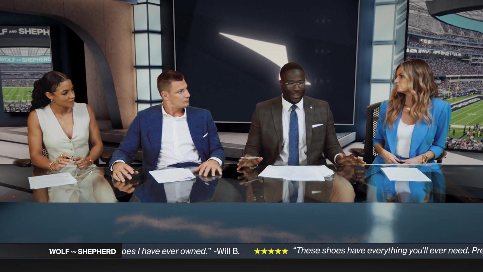 Commercial: four presenters at a sports-analysis desk above a stadium backdrop, a SportsCenter-style set for a Wolf & Shepherd spot at L.A. & ABQ Castle Studios