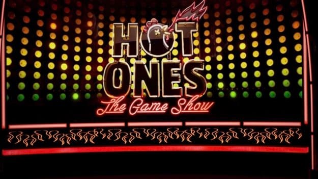 Game show set — a glowing red and gold game show title wall framed by rows of lit dots, a virtual production set at L.A. & ABQ Castle Studios
