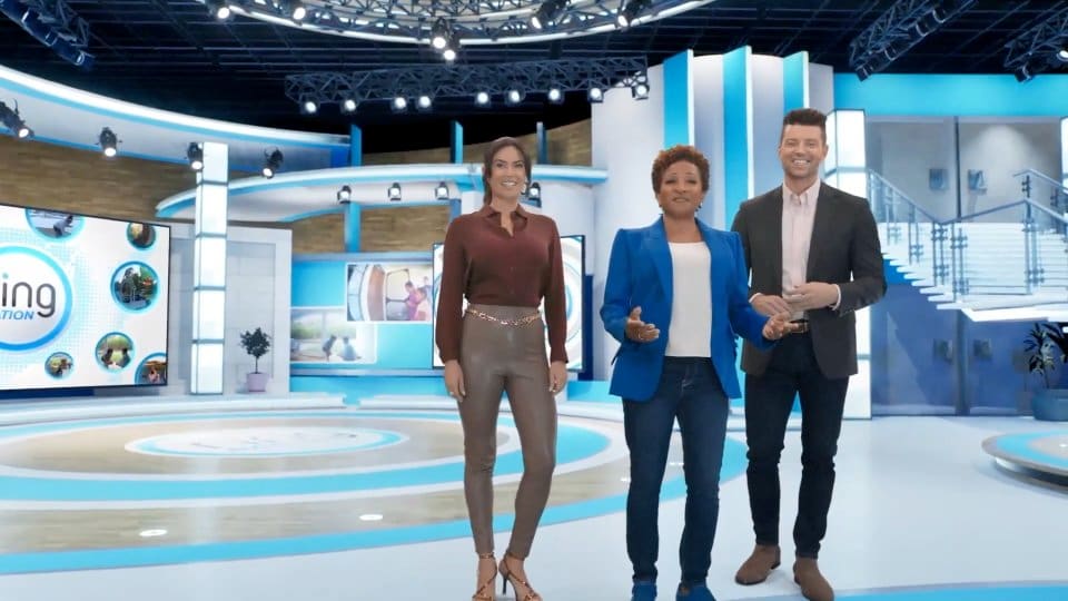 Host wrap — three presenters smile together on a bright blue-and-white morning-show set, a virtual production set at L.A. & ABQ Castle Studios