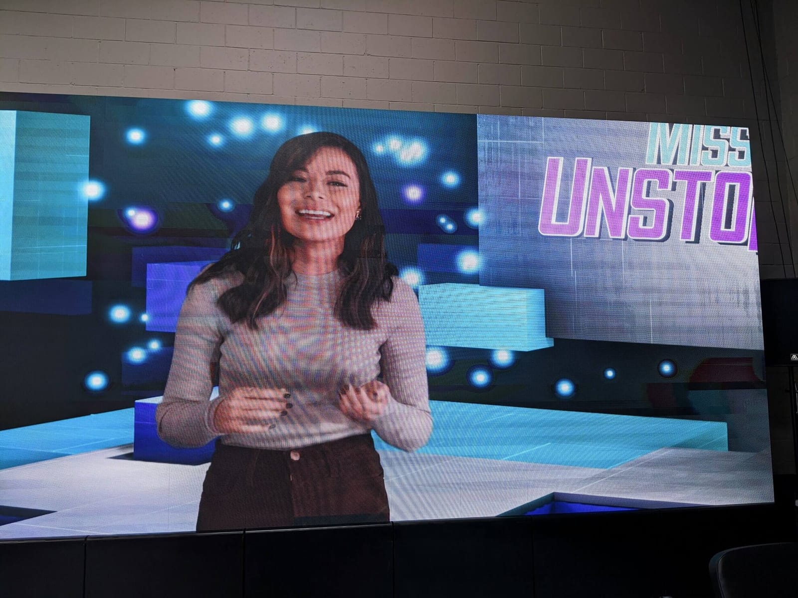 Host wrap: a presenter on the 'Mission Unstoppable' set, shown on the Burbank studio's giant LED video village wall