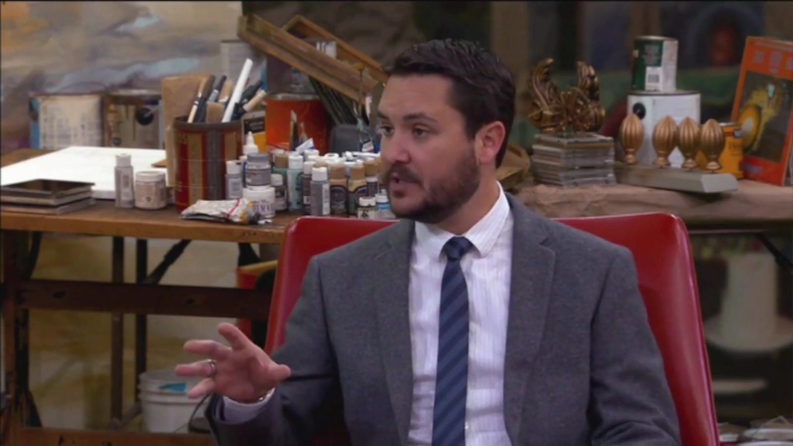 Press junket: a guest in a red armchair on an artist's workshop virtual set, a press junket interview at L.A. & ABQ Castle Studios