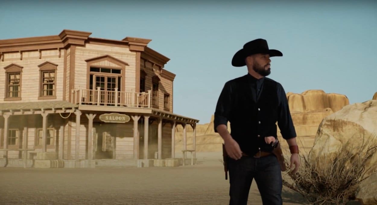 An actor in a cowboy hat before a desert Western town and saloon, one of the Unreal Engine virtual sets available for vertical drama and micro-series shoots at L.A. & ABQ Castle Studios